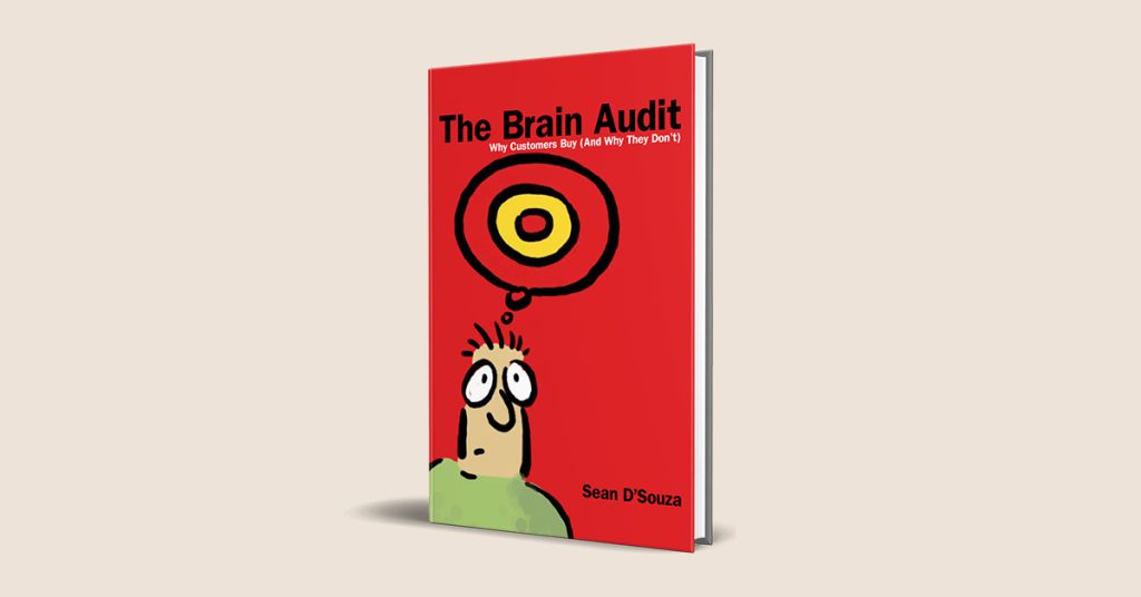 ปกหนังสือสีส้มแดงชื่อ The Brain Audit พร้อมภาพการ์ตูนคนที่มีสัญลักษณ์เป้าหมายลอยอยู่เหนือศีรษะในความคิด